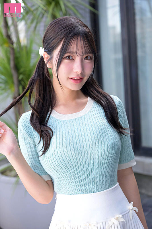 水色ニットと白ミニスカート姿でベッドに腰掛け、足を伸ばしてこちらを見つめる福田ゆあのサンプル画像